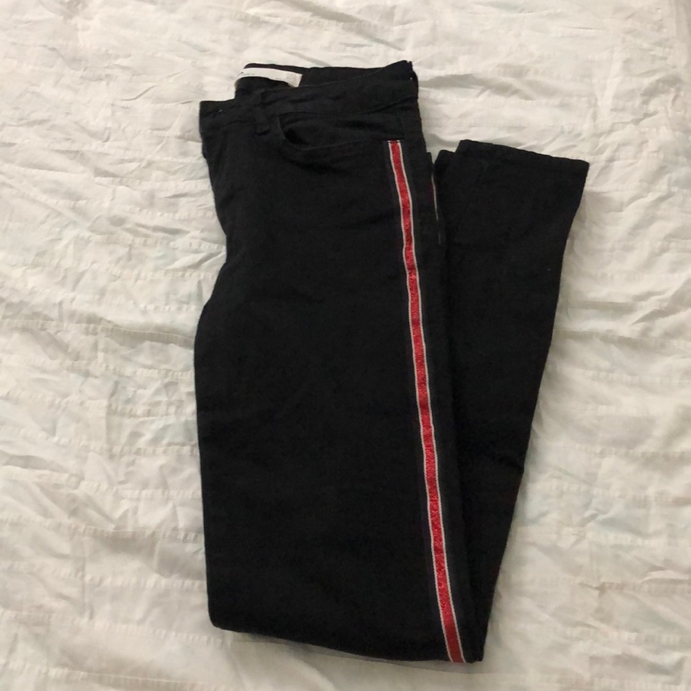 Low waisted black skinny jeans with red stripes